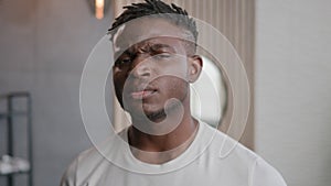 African American man looking at camera serious unhappy facial expression negative emotion morning hygiene procedures