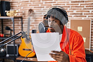 African american man musincian singing song at music studio