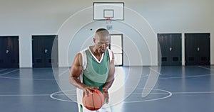 African American man playing basketball indoors, with copy space