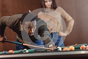 african american man playing in pool