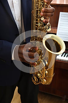 African-American man playing saxophone,. Talented musician