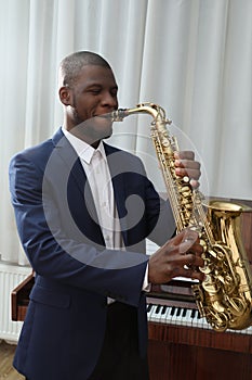 African-American man playing saxophone. Talented musician