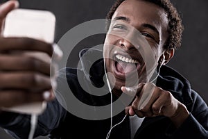 African American man pointing at phone screen