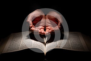 African American Man Praying with Hands Open on Top of the Bible