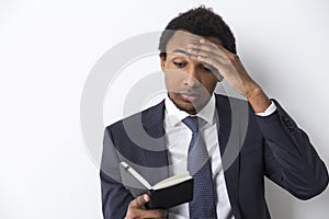 African American man reading a black notebook