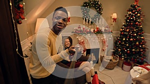 African American man records video on Christmas family dinner