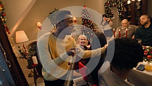 African American man records video on Christmas family dinner