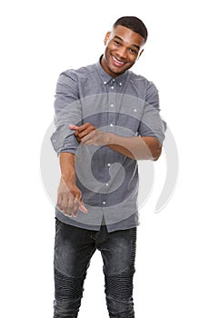 African american man smiling and rolling up sleeves