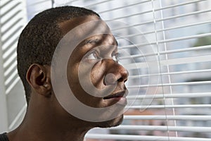 African American man smiling at window, horizontal