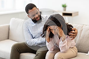 African american man soothing and comforting his crying stressed woman