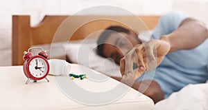African-american man suffering from insomnia in bed