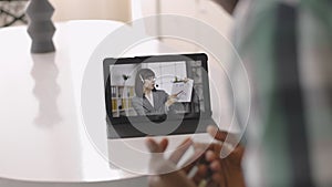 African American man with tablet pc computer having video call with his female colleague