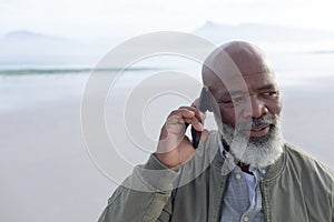 African-American man talking on the phone at the beach