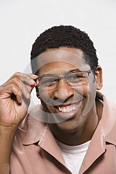 African American Man Trying On Glasses Isolated Over White