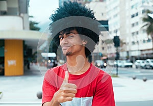 African american man with typical afro hair showing thumb up