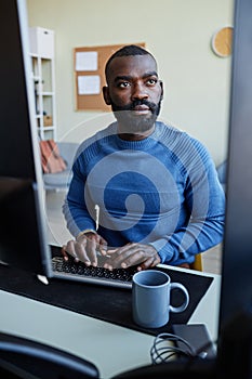 African American Man Using Computer For Programming