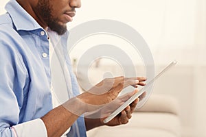 African-american man using digital tablet at home