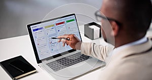 African-American Man Using Kanban Project Management Software