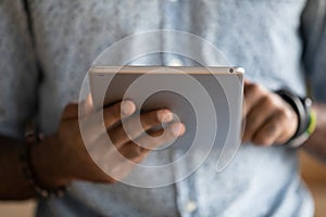 African American man using modern tablet gadget