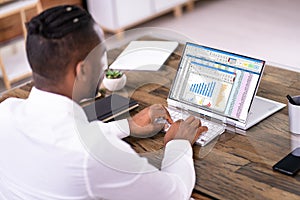 African American Man Using Spreadsheet Reports