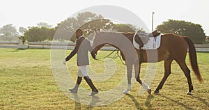 African American man walking with his dressage horse