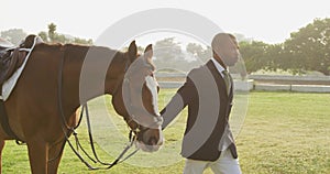 African American man walking with his dressage horse