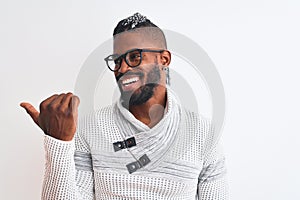 African american man wearing grey sweater and glasses over isolated white background smiling with happy face looking and pointing