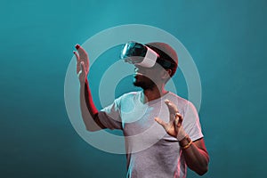 African american man wearing vr goggles with futuristic game