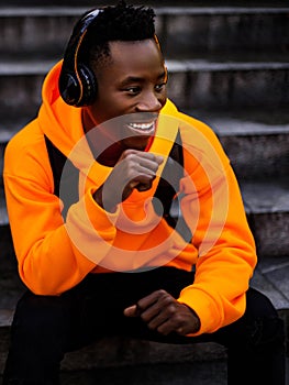 African-american man in wireless headphones listening music