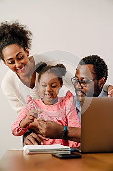 African american man and woman with daughter making notes in notepad
