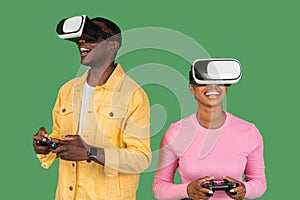 African american man and woman using VR glasses and consoles