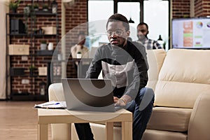 African american man working on laptop pc