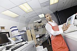 African American man working at printing press