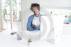 African American man working using computer happy face smiling with crossed arms looking at the camera