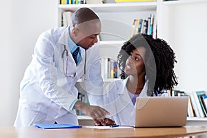 African american mature adult male doctor with nurse