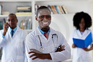 African american mature general practitioner with medical team