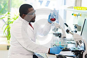 African-american medical doctor working in research lab. Science assistant making pharmaceutical experiments. Chemistry