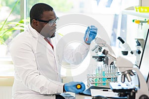 African-american medical doctor working in research lab. Science assistant making pharmaceutical experiments. Chemistry