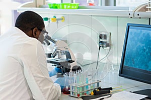 African-american medical doctor working in research lab. Science assistant making pharmaceutical experiments. Chemistry