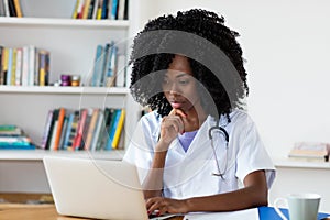 African american medical student learning at computer