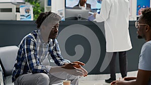 African american men sitting in waiting area at facility
