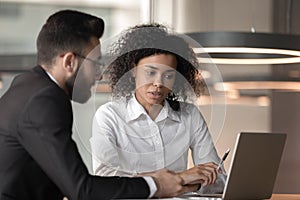 African American mentor training intern, helping with corporate software