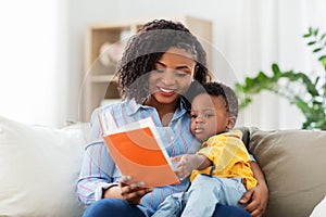 African american mother with book and baby at home