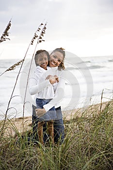 African-American mother and daughter at beach