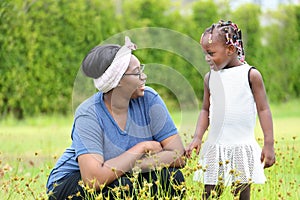 African American mother and daughter enjoy spending time together in the park at summer time