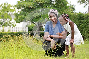 African American mother and daughter enjoy spending time together in the park at summer time