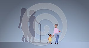 African american mother with daughter holding hands shadow of young and mature woman standing together imagination