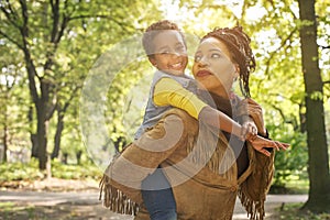 African American mother with daughter in park.