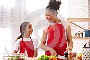 African American mother and daughter preparing