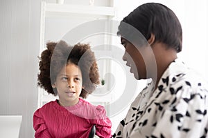 African American mother and daughter. Woman togetherness concept : Mom and afro kid in a cheerful friendship family